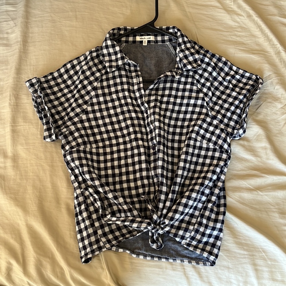 Button down short sleeved blouse with ties at the waist. Light and airy!